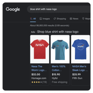 Google search results for blue shirt with NASA logo display ads featuring three shirts: a red one with the NASA Worm Logo for $32, a blue shirt for $15.90, and another featuring the NASA Meatball Logo for $35.99, showcasing effective digital marketing services in action.