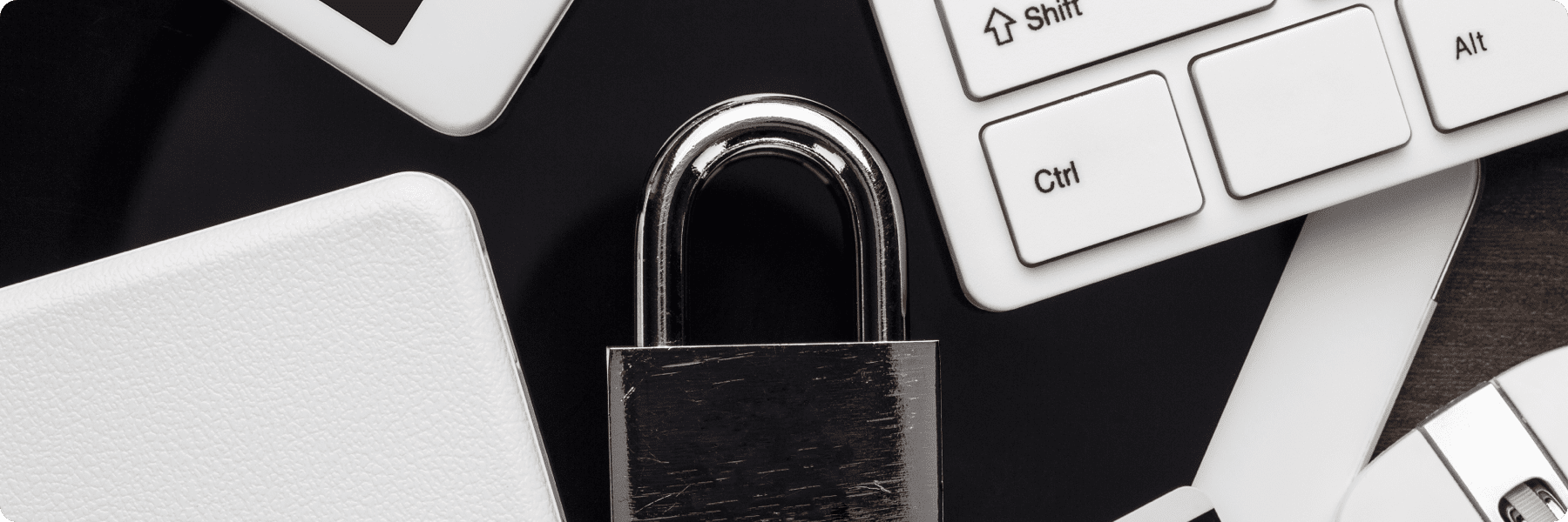 A silver padlock sits amidst various digital devices, like a keyboard and smartphone, symbolizing cybersecurity. This setup underscores the importance of secure web design and fortifies the trust needed in todays digital marketing services landscape.