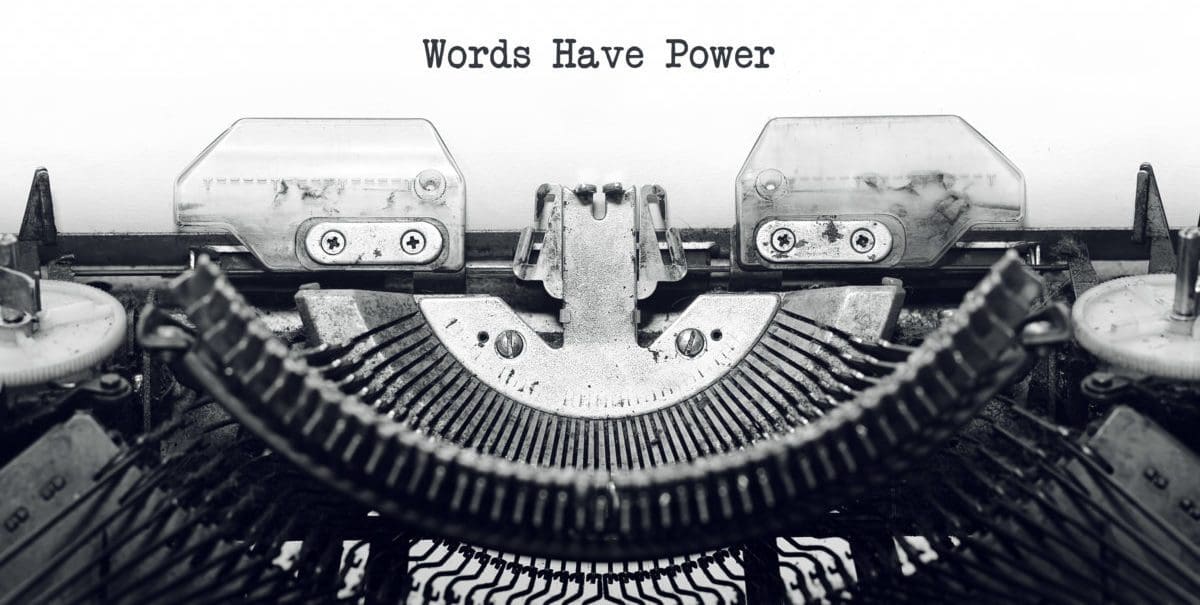 Close-up of a typewriter with Words Have Power typed on paper, highlighting the central metal components and text. This black and white image evokes a classic, vintage feel—a timeless reminder for any digital marketing company that words drive impact.