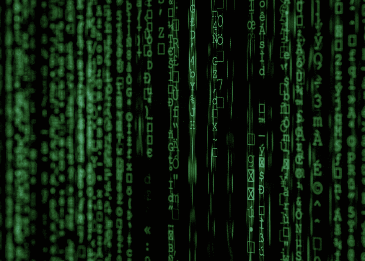 Green computer code resembling falling text is displayed on a black background, reminiscent of a digital marketing agencys innovative touch. Various symbols and characters form vertical lines, evoking a futuristic or sci-fi ambiance.