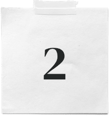 A white sticky note with a piece of tape at the top, displaying the number 2 in bold black font—perfect for reminders at your marketing agency.