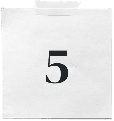 A white paper with the number 5 printed in bold black font, taped at the top—a perfect metaphor for our web design approach: clear, bold, and impactful.