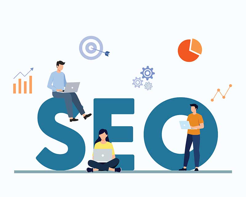 Illustration of three people with laptops sitting and standing on large SEO letters, surrounded by icons of graphs, a target, gears, and a pie chart, symbolizing search engine optimization and data analysis.