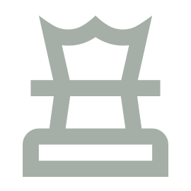 A simple gray icon of a chair with a crown-shaped backrest, resembling a throne, on a light background.